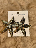 Aretes maxi pegados en forma de estrella de mar dorado